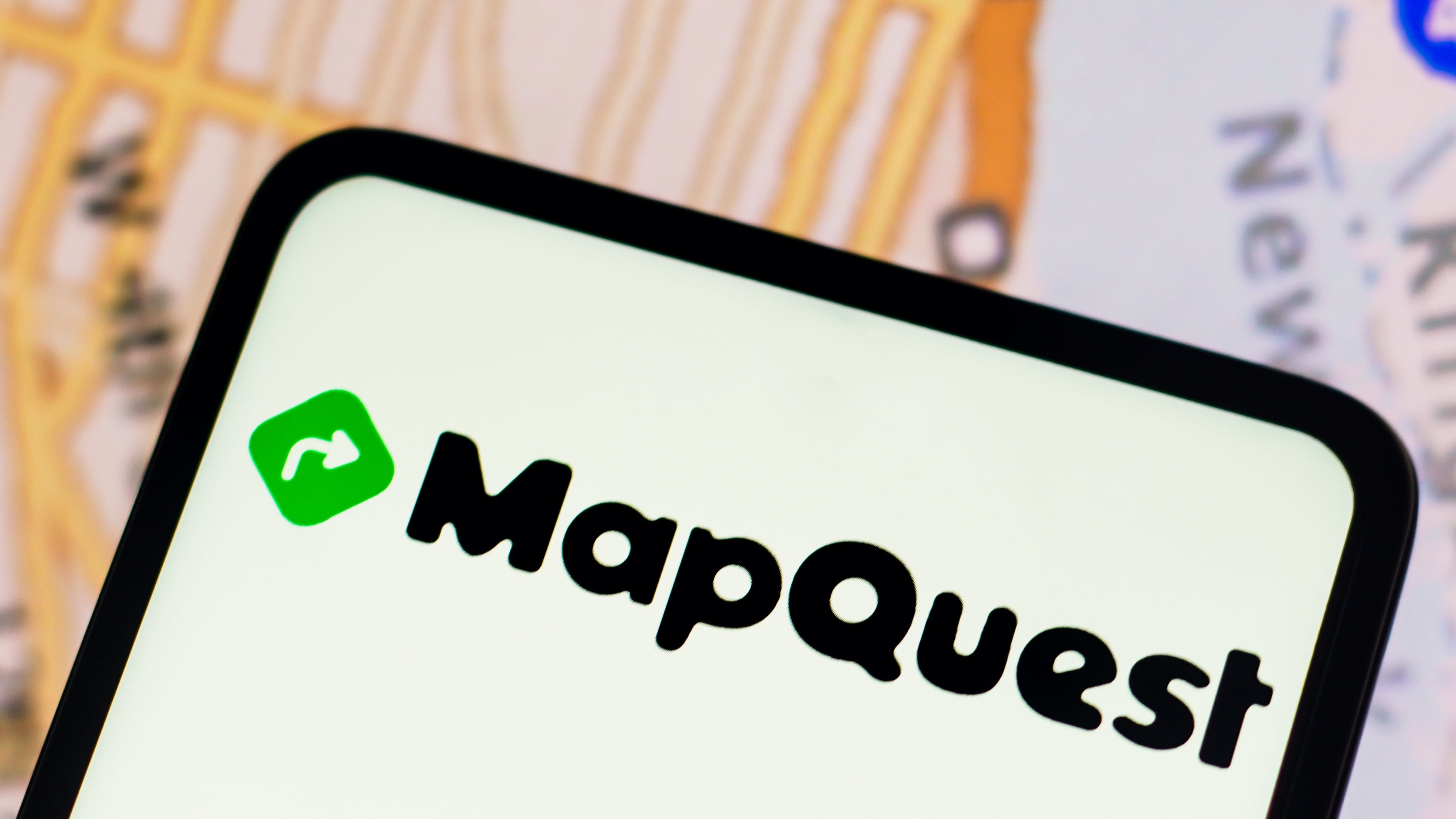 MapQuest logo is displayed on a smartphone screen